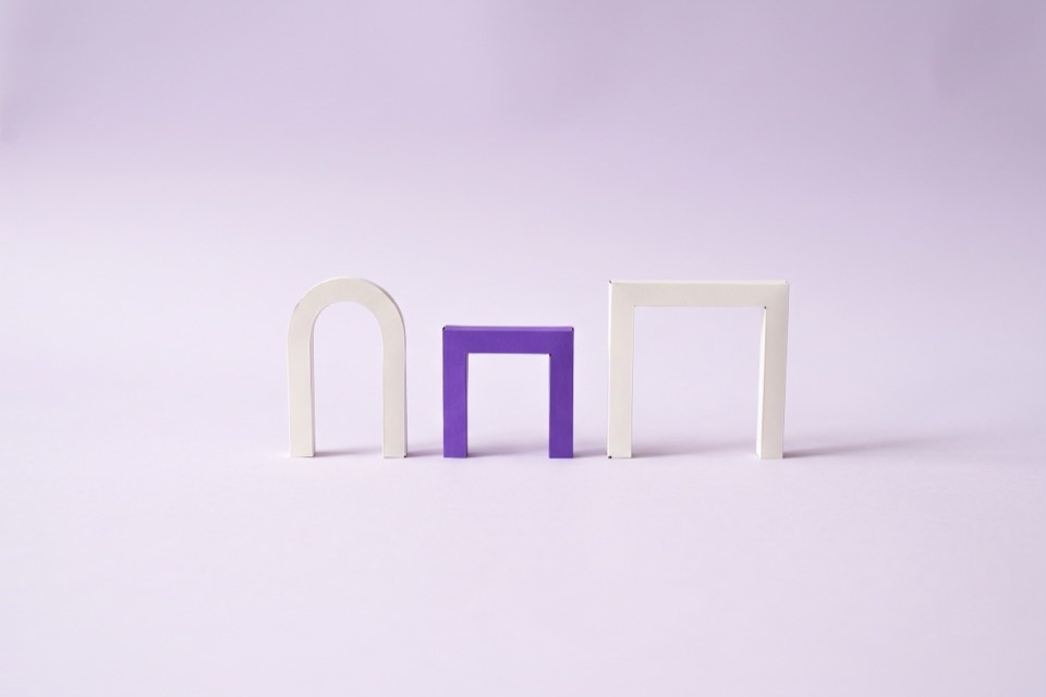 Three small doorway shapes in a row, the middle one violet
