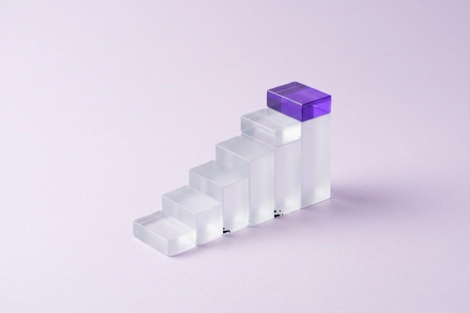 Frosted glass blocks rising like a staircase, the top step violet