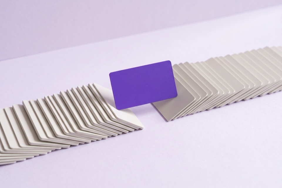 Two long rows of blank cards with one violet card lifted out between them